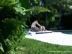 Big tit girlfriend giving a handjob outside by the pool