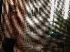 Voyeur secretly films his milf neighbor through window